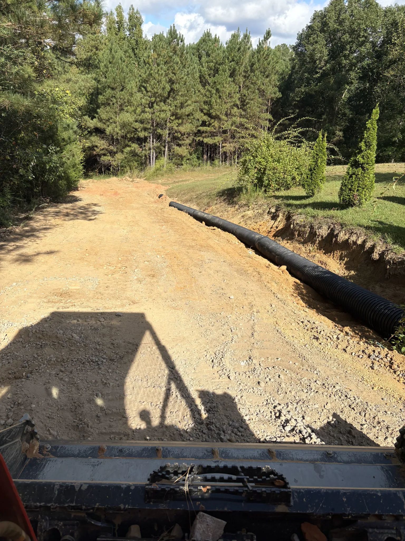 Driveway and drainage work viewed from construction equipment during grading